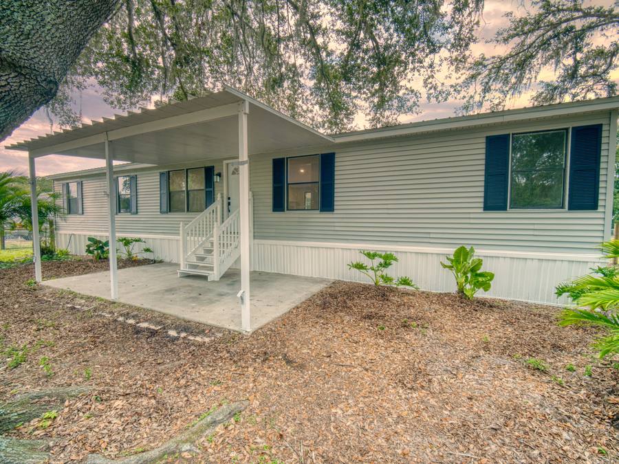 Renovated manufactured home with covered carport and new landscaping